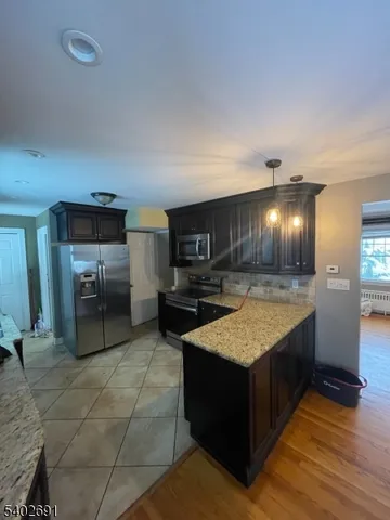 a large kitchen with kitchen island granite countertop a large counter top and sink