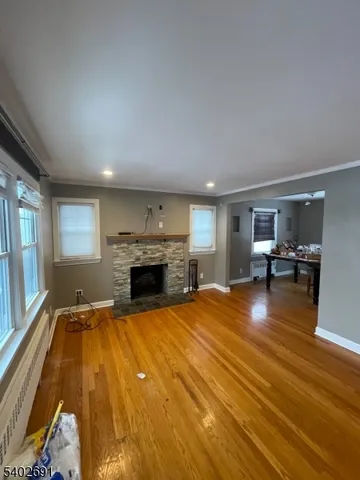 a view of a livingroom with furniture fireplace and windows