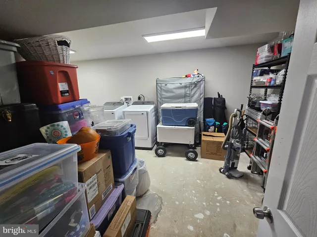 a room with furniture a washer and a book shelf