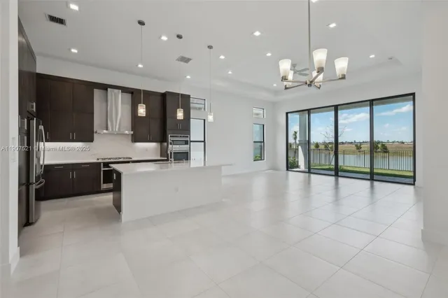 a large kitchen with a large counter top and stainless steel appliances