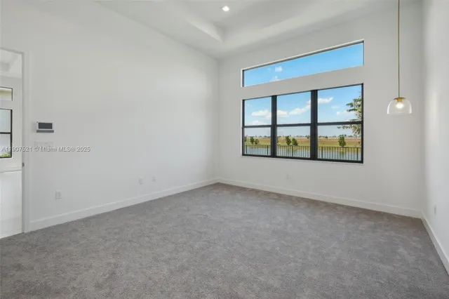 an empty room with windows and entrance