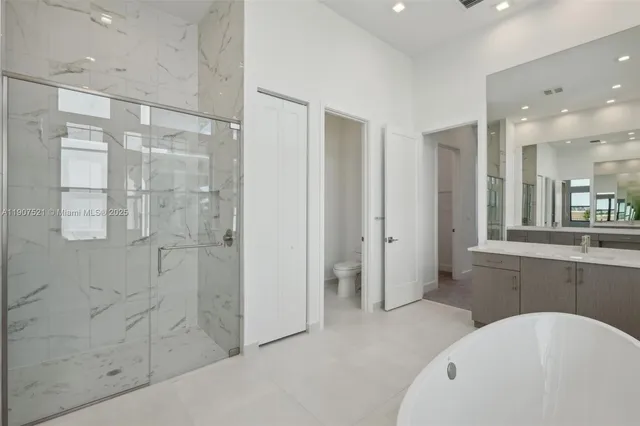 a bathroom with a bathtub shower and sink