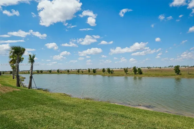 a view of a lake with houses in the background