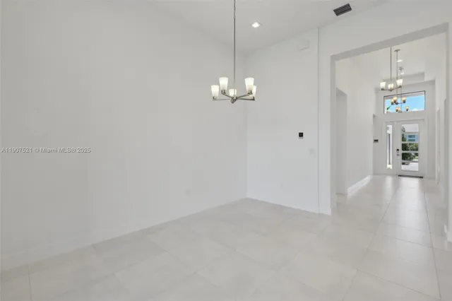 a view of a chandelier in big room and chandelier