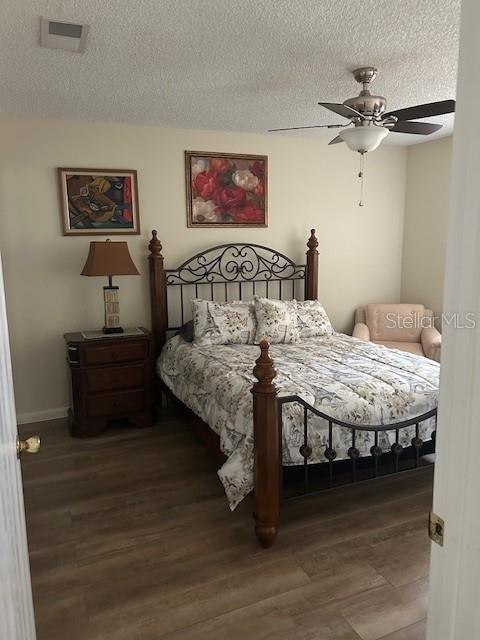 9748 Southwest 97th Street Ocala, FL 34481 - Photo 12 of 16 a bedroom with a bed and a table