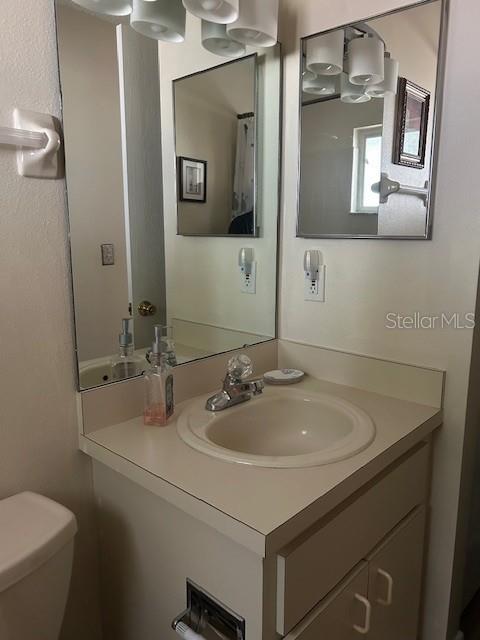 9748 Southwest 97th Street Ocala, FL 34481 - Photo 15 of 16 a bathroom with a sink and a mirror with toilet