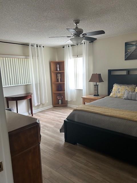 9748 Southwest 97th Street Ocala, FL 34481 - Photo 7 of 16 a bedroom with a bed and a chair