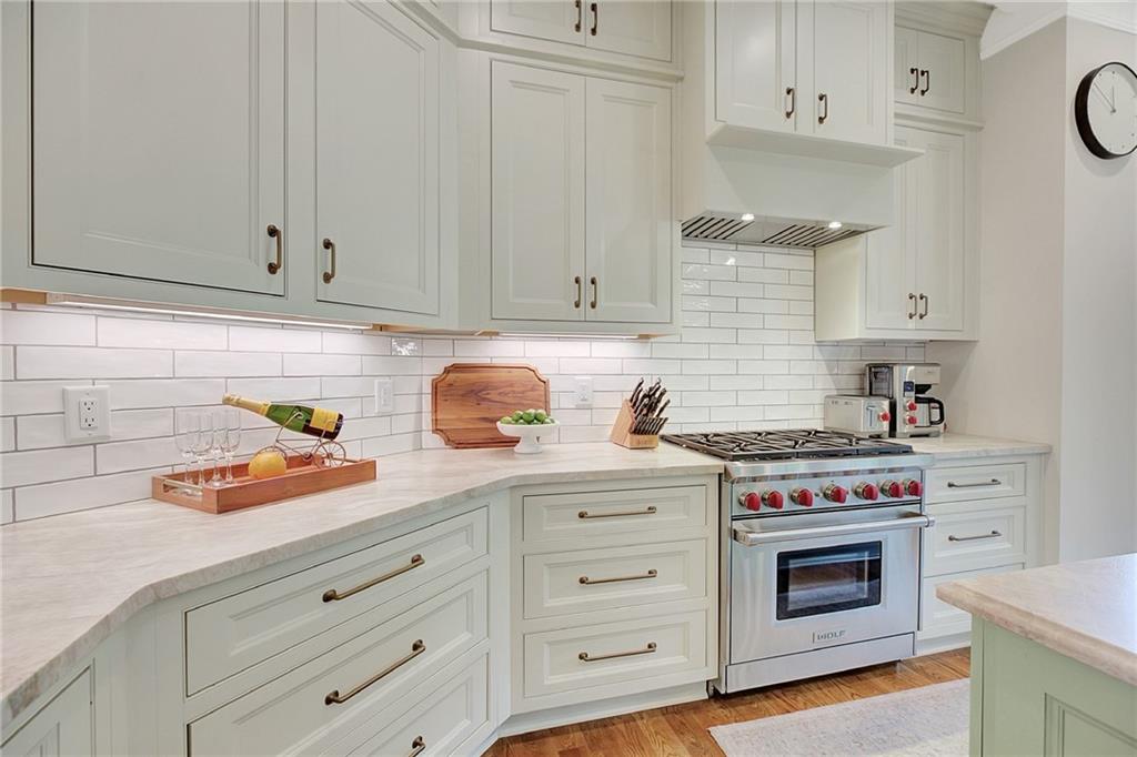 25 Paragon Point Newnan, GA 30265 - Photo 34 of 127 a kitchen with granite countertop white cabinets and stainless steel appliances