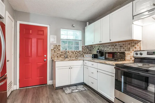 a kitchen with stainless steel appliances granite countertop a stove sink and cabinets
