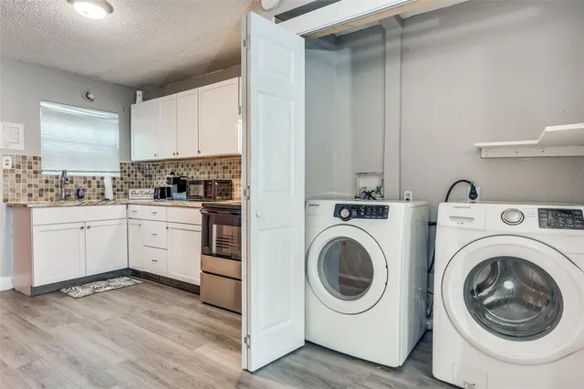 a kitchen with a stove top oven sink and cabinets