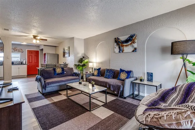 a living room with furniture and wooden floor