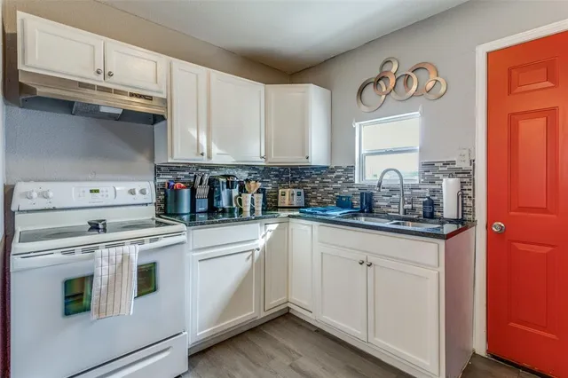a kitchen with stainless steel appliances granite countertop a sink and cabinets