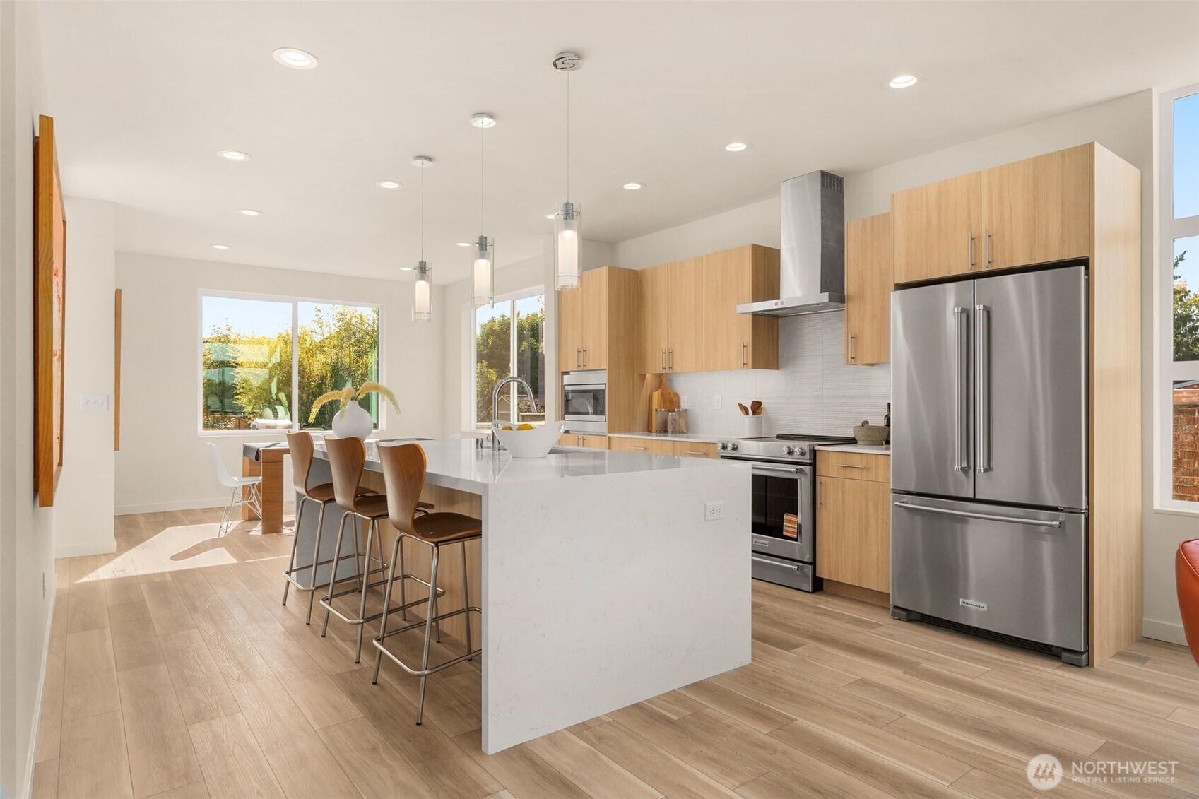 4853 South Findlay Street Seattle, WA 98118 - Photo 5 of 32 a kitchen with a refrigerator a dining table and chairs