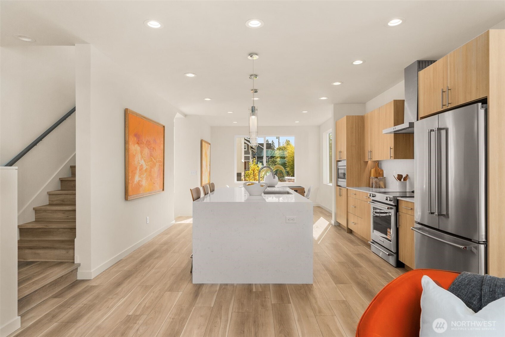 4853 South Findlay Street Seattle, WA 98118 - Photo 8 of 32 a large kitchen with stainless steel appliances granite countertop a refrigerator a oven a dining table and chairs with wooden floor