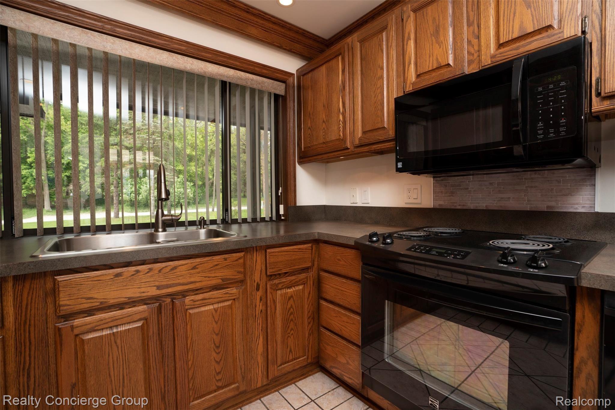 Kitchen includes large picture window that overlooks the property and gives tons of natural light to this room