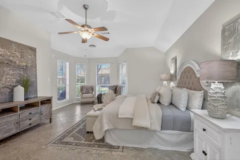a living room with furniture a large window and a chandelier
