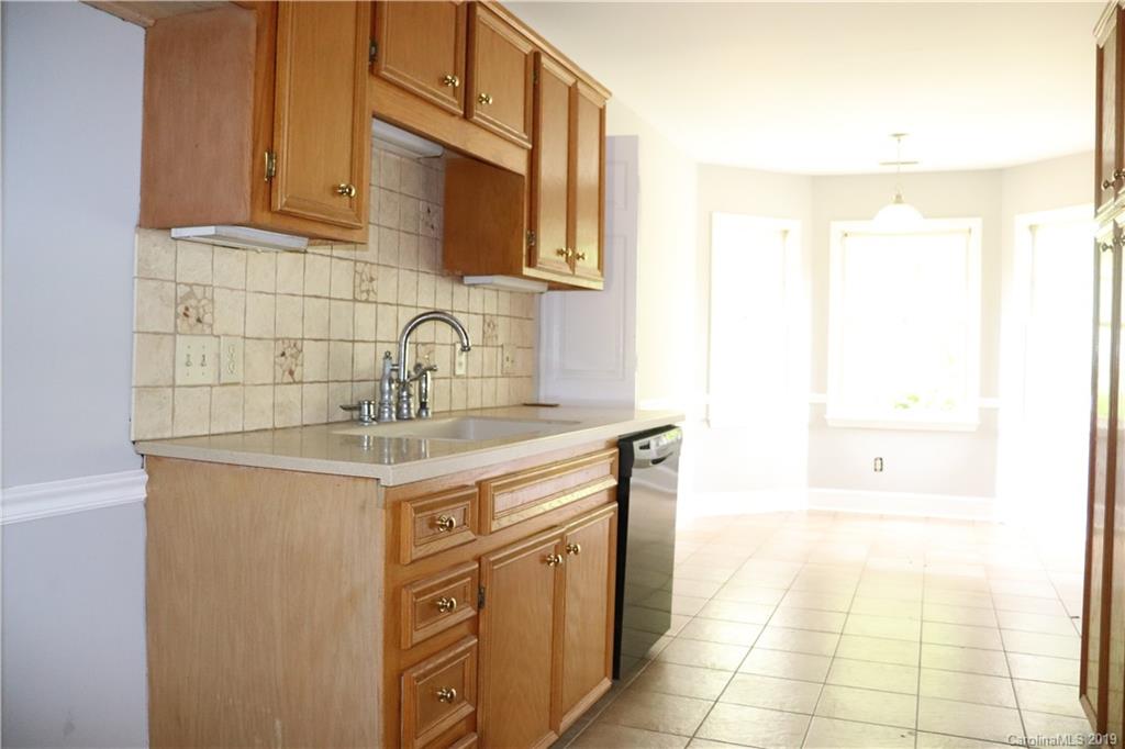 6520 Medlin Road Monroe, NC 28112 - Photo 12 of 22 a kitchen with stainless steel appliances granite countertop a sink and cabinets