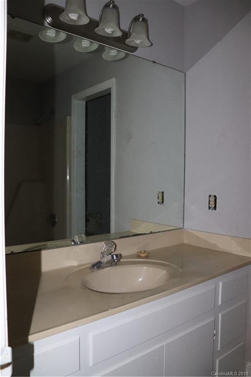 6520 Medlin Road Monroe, NC 28112 - Photo 15 of 22 a bathroom with a sink and a mirror
