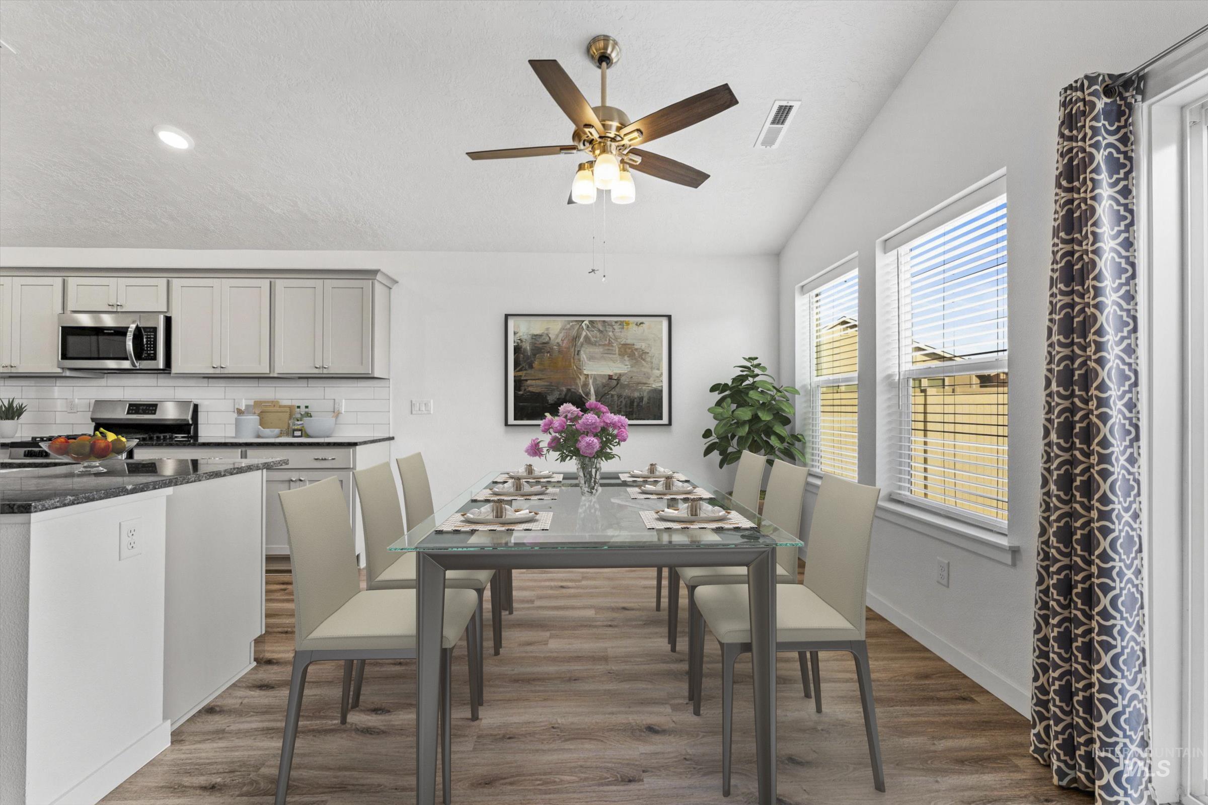 17798 Goose Ridge Avenue Nampa, ID 83687 - Photo 10 of 30 Dining area with dark wood-type flooring, a ceiling fan, and vaulted ceiling