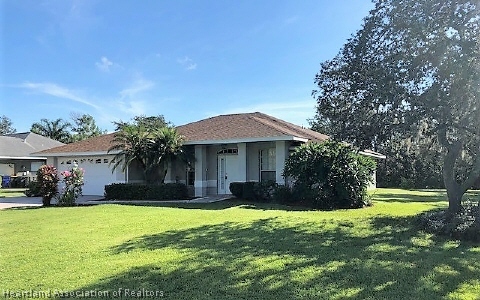 4570 Pebble Lane Sebring, FL 33872 - Photo 1 of 19 a front view of a house with a yard