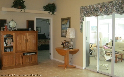 4570 Pebble Lane Sebring, FL 33872 - Photo 17 of 19 a living room with furniture a large window and a dining table