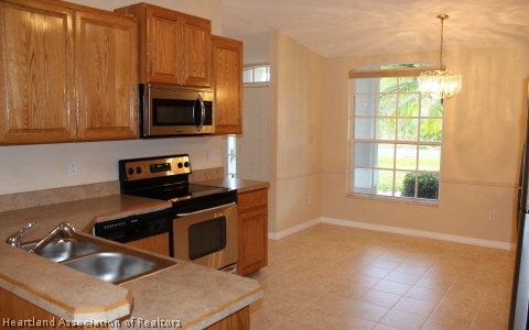 4570 Pebble Lane Sebring, FL 33872 - Photo 2 of 19 a kitchen that has a sink and a stove top oven