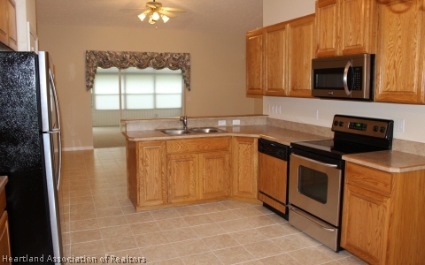 4570 Pebble Lane Sebring, FL 33872 - Photo 3 of 19 a kitchen with stainless steel appliances a sink stove and microwave