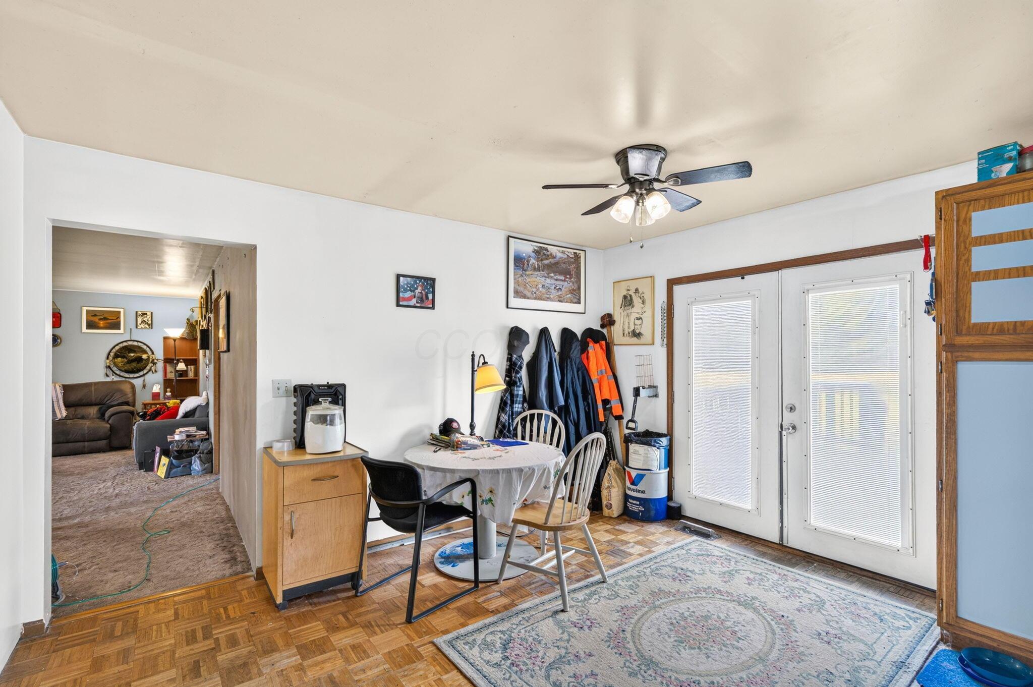 4780 North Section Line Road Radnor, OH 43066 - Photo 28 of 79 Double French doors, parquet wood-finish flooring, ceiling fan, built-in cabinetry, and a wide entryway