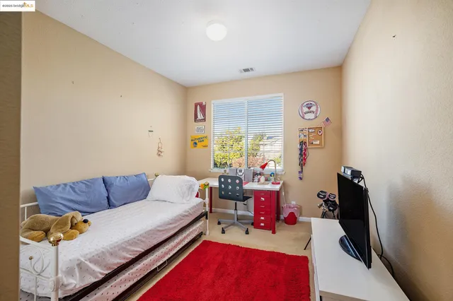a room with pool table and windows