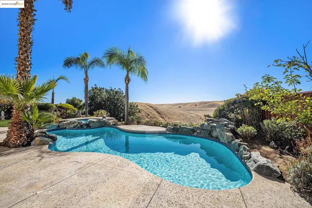 a view of a house with backyard sitting area and garden