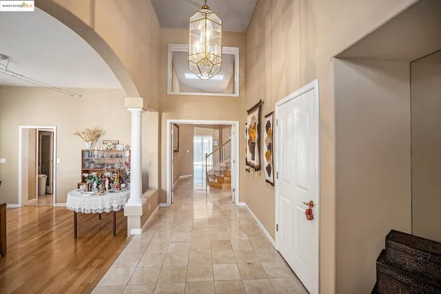 a view of a hallway with windows and stairs