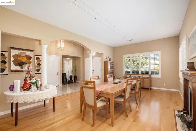 a view of a a dining room with furniture window and wooden floor