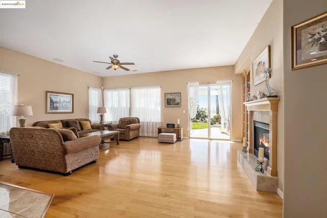 a kitchen with stainless steel appliances granite countertop a refrigerator a sink a stove and white cabinets