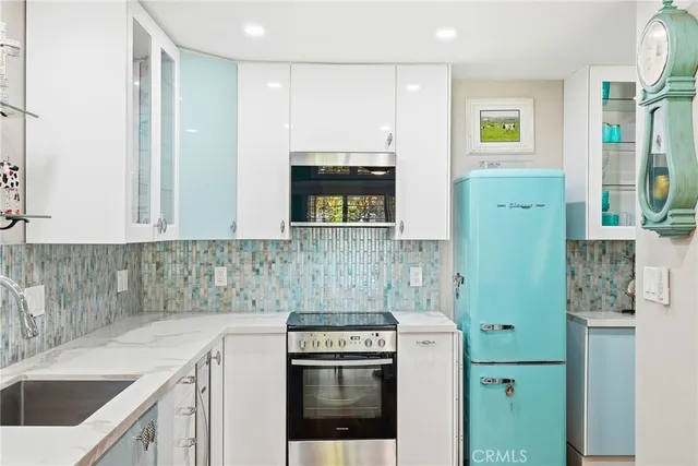 a kitchen with a sink stove and refrigerator
