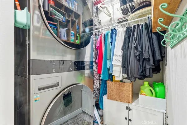 a view of walk in closet with clothes and shoes