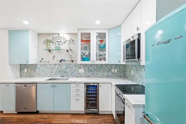 a kitchen with a sink cabinets and a wooden floor