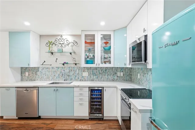 a kitchen with a sink cabinets and a wooden floor