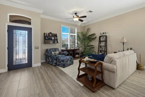 a kitchen with stainless steel appliances kitchen island granite countertop a stove a sink dishwasher and white cabinets with wooden floor