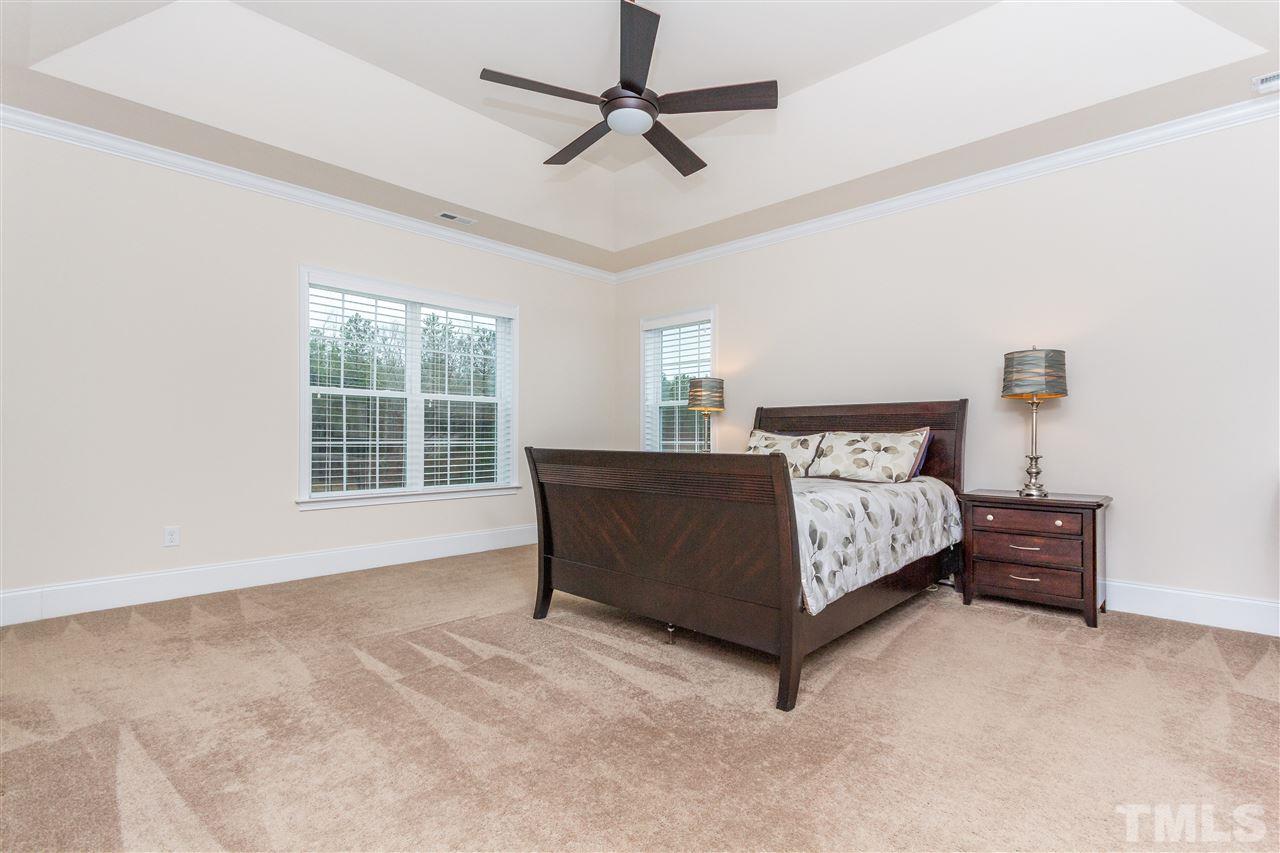 4600 Fielding Drive Raleigh, NC 27606 - Photo 13 of 25 a bedroom with a bed lamp and a window