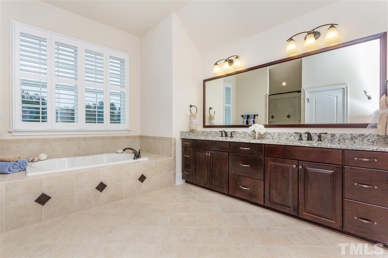 4600 Fielding Drive Raleigh, NC 27606 - Photo 14 of 25 a spacious bathroom with a tub sink and mirror