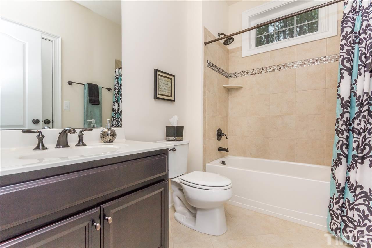 4600 Fielding Drive Raleigh, NC 27606 - Photo 19 of 25 a bathroom with a sink a toilet and a bathtub