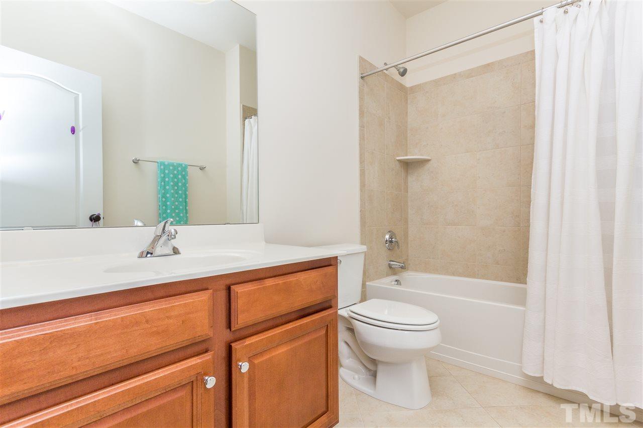 4600 Fielding Drive Raleigh, NC 27606 - Photo 21 of 25 a bathroom with a granite countertop sink a toilet and shower