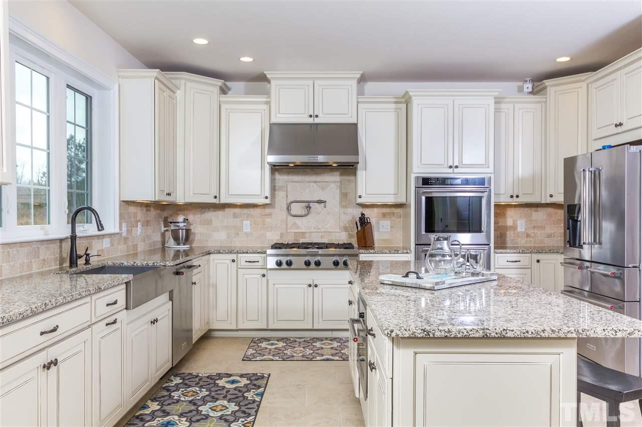 4600 Fielding Drive Raleigh, NC 27606 - Photo 6 of 25 a kitchen with stainless steel appliances granite countertop a sink stove and refrigerator