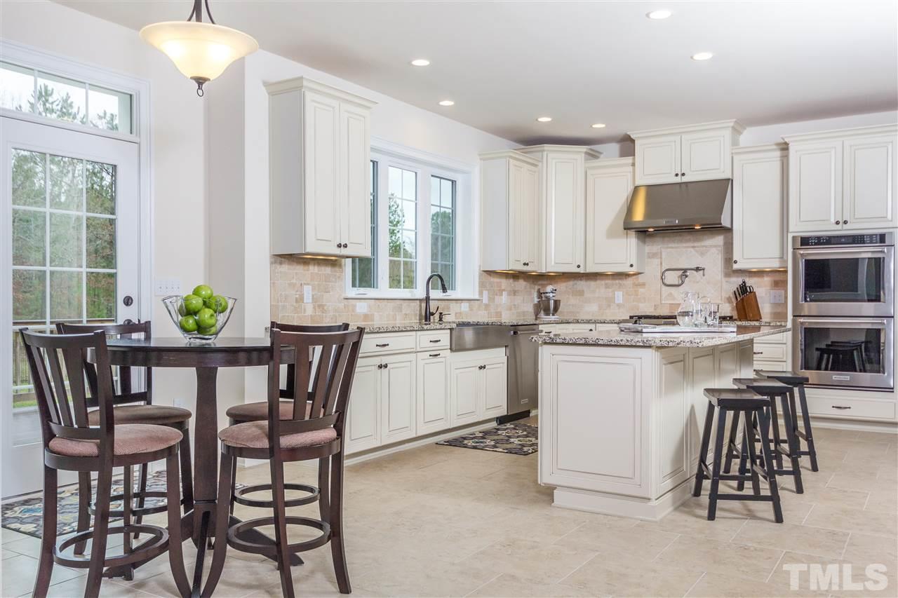 4600 Fielding Drive Raleigh, NC 27606 - Photo 7 of 25 a kitchen with a white table and chairs in it