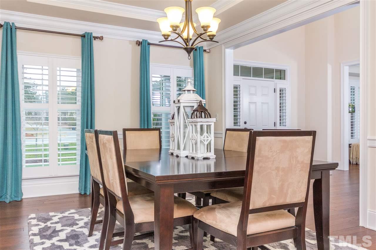 4600 Fielding Drive Raleigh, NC 27606 - Photo 10 of 25 a view of a dining room with furniture a chandelier and wooden floor