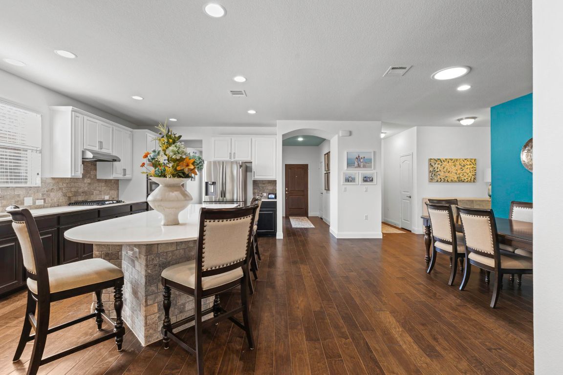 706 Kite Ridge Street Georgetown, TX 78633 - Photo 13 of 36 a view of a dining room with furniture and wooden floor