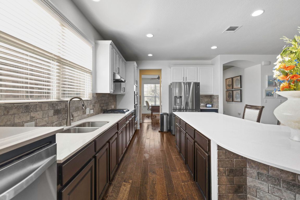 706 Kite Ridge Street Georgetown, TX 78633 - Photo 15 of 36 a kitchen with counter top space sink stove and refrigerator