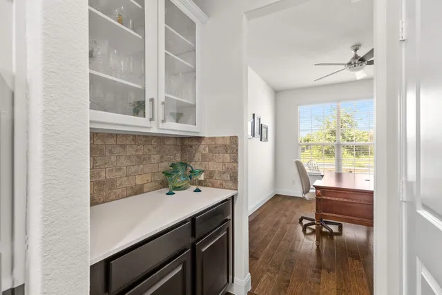 a kitchen with stainless steel appliances granite countertop dining table chairs refrigerator and sink