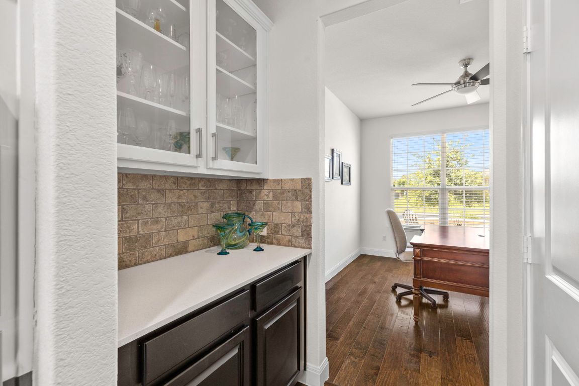 706 Kite Ridge Street Georgetown, TX 78633 - Photo 16 of 36 a hallway with a wooden floor and a large window
