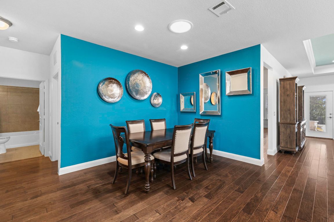 706 Kite Ridge Street Georgetown, TX 78633 - Photo 17 of 36 a view of a dining room with furniture and wooden floor
